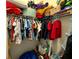 Walk-in closet with clothes and bins, providing ample storage space for organization and clutter-free living at 1055 Lena Run Ct, Winter Haven, FL 33880