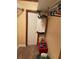 Walk-in closet with hanging storage, carpet floors and a red bin on the floor at 1405 N Lake Reedy Blvd, Frostproof, FL 33843