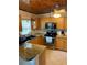 Traditional kitchen featuring oak cabinets, granite countertops, and stainless steel appliances at 1405 N Lake Reedy Blvd, Frostproof, FL 33843