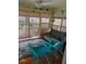 Screened porch with wicker furniture, wood-look floors and sliding glass doors at 1405 N Lake Reedy Blvd, Frostproof, FL 33843