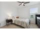 Cozy bedroom with a window view, bedside table, and a ceiling fan at 141 Claire Ln, Davenport, FL 33837