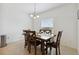 Bright dining room featuring a wooden table and chairs under a modern chandelier, next to the window at 141 Claire Ln, Davenport, FL 33837