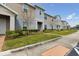 Well maintained townhome featuring a green lawn and tidy landscaping at 141 Claire Ln, Davenport, FL 33837