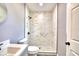 Modern bathroom featuring tiled shower, new toilet, and grey vanity at 1475 S Lake Howard Dr, Winter Haven, FL 33880