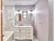 Bathroom with a modern vanity, marble countertop, and a tiled bathtub at 1475 S Lake Howard Dr, Winter Haven, FL 33880