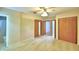 Spacious carpeted bedroom with closet space and ensuite bathroom at 1475 S Lake Howard Dr, Winter Haven, FL 33880