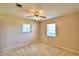 Bedroom featuring neutral carpeting, light-colored walls, and two windows at 1475 S Lake Howard Dr, Winter Haven, FL 33880