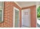 Brick exterior of house with a white door and window with louvers at 1475 S Lake Howard Dr, Winter Haven, FL 33880