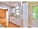 Well-lit kitchen featuring modern appliances, granite countertops, and ample cabinet space at 1475 S Lake Howard Dr, Winter Haven, FL 33880