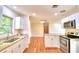 Open-concept kitchen with stainless steel appliances and granite countertops, perfect for modern living at 1475 S Lake Howard Dr, Winter Haven, FL 33880