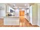 Bright kitchen featuring granite countertops, stainless steel appliances, and hardwood floors at 1475 S Lake Howard Dr, Winter Haven, FL 33880
