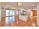 Spacious open-concept living room connected to a modern kitchen, featuring hardwood floors and natural light at 1475 S Lake Howard Dr, Winter Haven, FL 33880