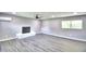 Living room with modern fireplace, laminate floors, and bright window at 1475 S Lake Howard Dr, Winter Haven, FL 33880