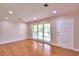 Inviting living room featuring hardwood floors, ample natural light, and a neutral color palette at 1475 S Lake Howard Dr, Winter Haven, FL 33880