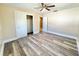 Bedroom with closet, ceiling fan, and view to hall with tiled floor at 1819 4Th Se Ct, Winter Haven, FL 33880