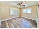 Bright bedroom features a ceiling fan, neutral walls, and wood-look floors at 1819 4Th Se Ct, Winter Haven, FL 33880