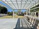 View from under pergola to backyard with bar, deck, lawn and privacy fence at 1819 4Th Se Ct, Winter Haven, FL 33880