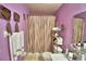 A cozy bathroom with a toilet, shower, and colorful purple walls at 200 El Camino Dr # 202, Winter Haven, FL 33884