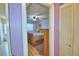 Bedroom with purple walls featuring a ceiling fan and wood-look floors at 200 El Camino Dr # 202, Winter Haven, FL 33884