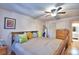 Sunlit bedroom with wood floors, bright pillows, and ample natural light at 200 El Camino Dr # 202, Winter Haven, FL 33884