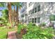 Apartment building exterior featuring a patio with lush, colorful gardens at 200 El Camino Dr # 202, Winter Haven, FL 33884