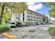 Condo building features multiple levels, balconies, and ample parking in a well-maintained community setting at 200 El Camino Dr # 202, Winter Haven, FL 33884