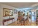 Open-concept dining room with hardwood floors that transitions to the living room at 200 El Camino Dr # 202, Winter Haven, FL 33884