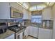Bright kitchen with granite countertops, stainless steel appliances, and custom cabinets at 200 El Camino Dr # 202, Winter Haven, FL 33884