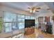 Bright seating area with a large window, a ceiling fan, and stylish decor accents at 200 El Camino Dr # 202, Winter Haven, FL 33884