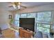 Comfortable living room featuring bright windows and wood-look floors, perfect for relaxation and natural light at 200 El Camino Dr # 202, Winter Haven, FL 33884