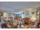 Open-concept living room with hardwood floors, showing the dining area and comfortable seating at 200 El Camino Dr # 202, Winter Haven, FL 33884