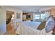 Inviting main bedroom with cozy bed, wood-look floors, and an open doorway to an adjoining room, ideal for relaxation at 200 El Camino Dr # 202, Winter Haven, FL 33884