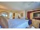 Relaxing main bedroom with a large bed, wood-look floors, and access to ensuite bathroom, perfect for unwinding at 200 El Camino Dr # 202, Winter Haven, FL 33884