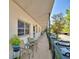 Apartment patio with outdoor seating and community parking views at 200 El Camino Dr # 202, Winter Haven, FL 33884