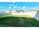 Spacious backyard featuring a well-maintained lawn and a privacy fence at 2005 Carnostie Rd, Winter Haven, FL 33884