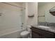 A well-equipped bathroom features a shower-tub combo, granite vanity, and ample lighting at 2005 Carnostie Rd, Winter Haven, FL 33884
