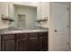 Bathroom featuring a double vanity with granite countertop, a large mirror, and shelving at 2005 Carnostie Rd, Winter Haven, FL 33884