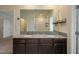 Bathroom featuring a double vanity with a granite countertop and large mirror at 2005 Carnostie Rd, Winter Haven, FL 33884