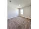 Bright, carpeted bedroom with a large window and neutral paint at 2005 Carnostie Rd, Winter Haven, FL 33884