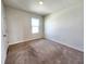 Neutral bedroom with carpet and a large window providing plenty of natural light at 2005 Carnostie Rd, Winter Haven, FL 33884