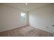 Cozy bedroom with carpet flooring, neutral walls, and a window providing natural light at 2005 Carnostie Rd, Winter Haven, FL 33884