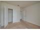 Bright, carpeted bedroom featuring an open closet, neutral paint, and a door leading to a tiled bathroom at 2005 Carnostie Rd, Winter Haven, FL 33884