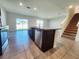 Modern kitchen featuring dark cabinets, granite countertops, stainless steel appliances, and a center island at 2005 Carnostie Rd, Winter Haven, FL 33884