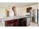 Modern kitchen featuring dark cabinets, granite countertops, stainless steel appliances, and a center island at 2005 Carnostie Rd, Winter Haven, FL 33884