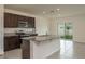 Modern kitchen featuring dark cabinets, granite countertops, stainless steel appliances, and a center island at 2005 Carnostie Rd, Winter Haven, FL 33884