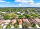 Aerial view of homes with tile roofs, showcasing the manicured lawns, landscaping, and a green space at 208 Lake Region S Blvd, Winter Haven, FL 33881