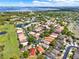 Beautiful aerial view of homes in a community near a lake with mature trees and landscaping at 208 Lake Region S Blvd, Winter Haven, FL 33881