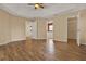 Large bedroom with tray ceilings, wood-look tile floor, and access to bathroom and walk-in closet at 208 Lake Region S Blvd, Winter Haven, FL 33881