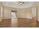 Open bedroom features tray ceilings, wood-look tile floor, and sliding glass door to outdoor patio at 208 Lake Region S Blvd, Winter Haven, FL 33881