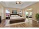 This bedroom features a tray ceiling, wood floors, and a sliding glass door that provides lots of light at 208 Lake Region S Blvd, Winter Haven, FL 33881